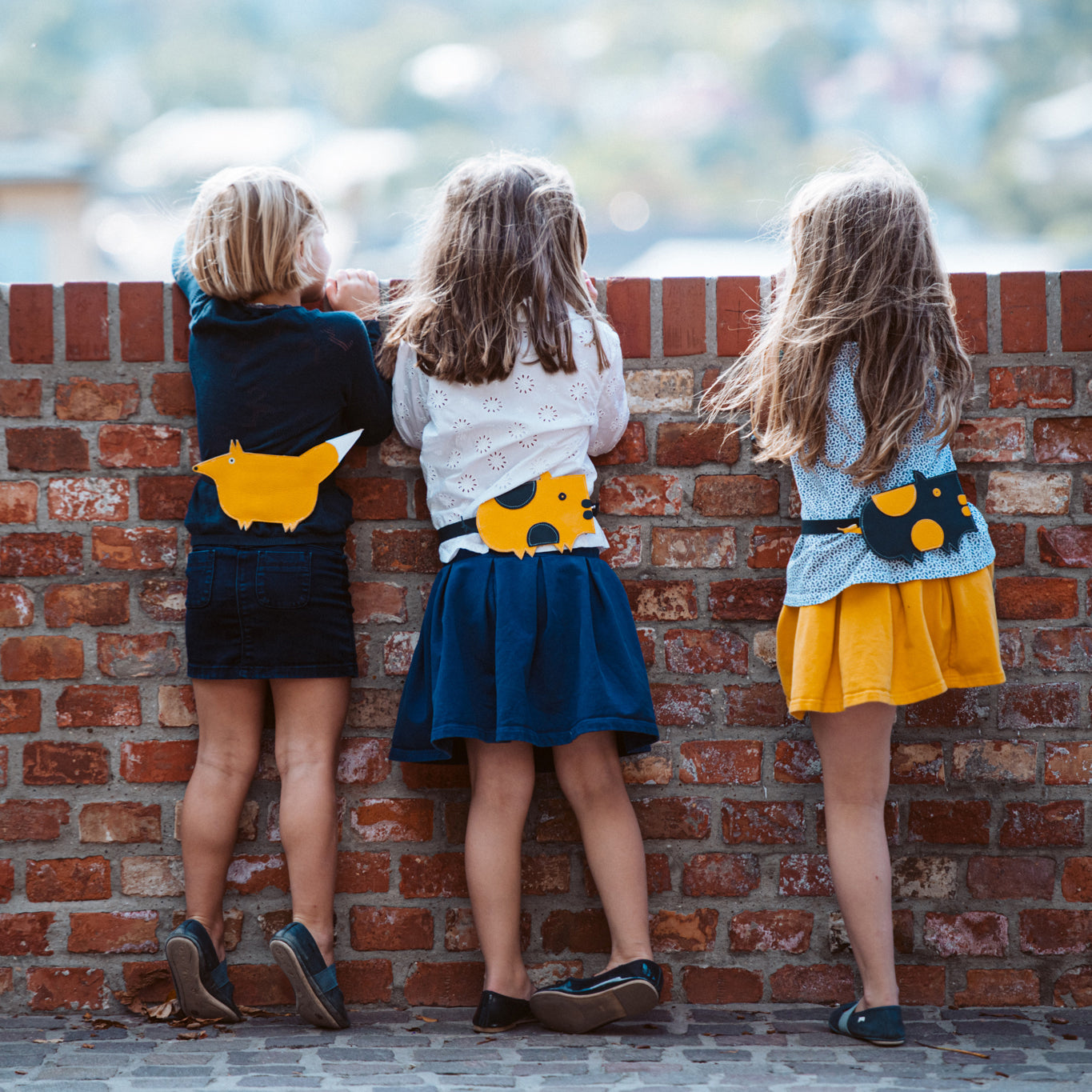 Children wearing Eperfa leather belt bags