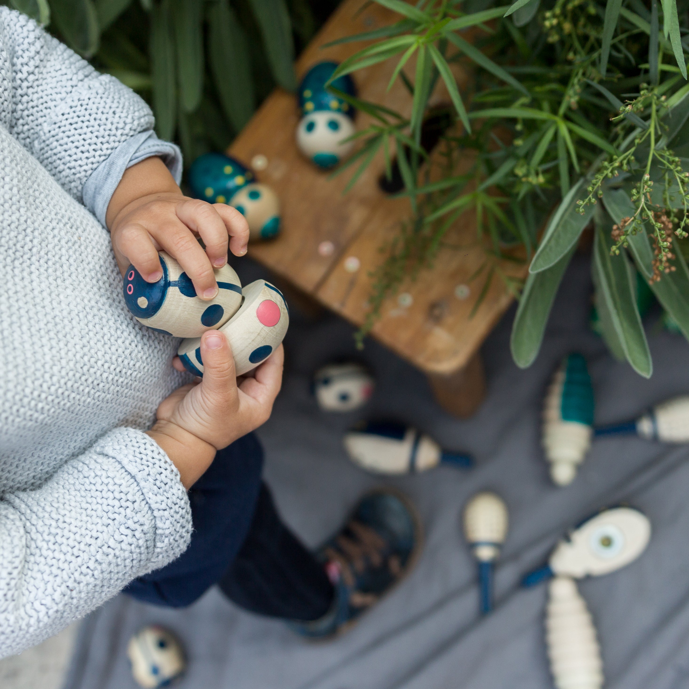 Child playing with Eperfa wooden beetles