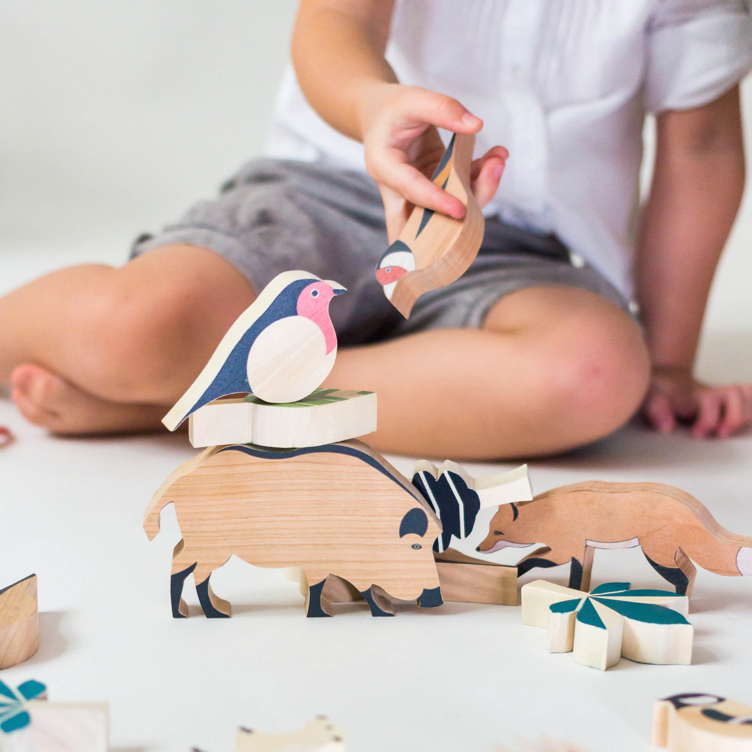 Child playing with Eperfa wooden hillside animals set